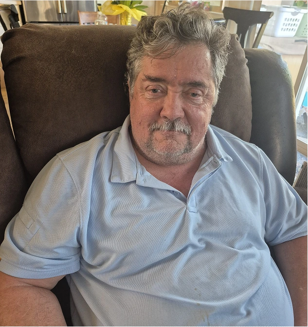 Portrait of author Shawn Lemison seated at home.